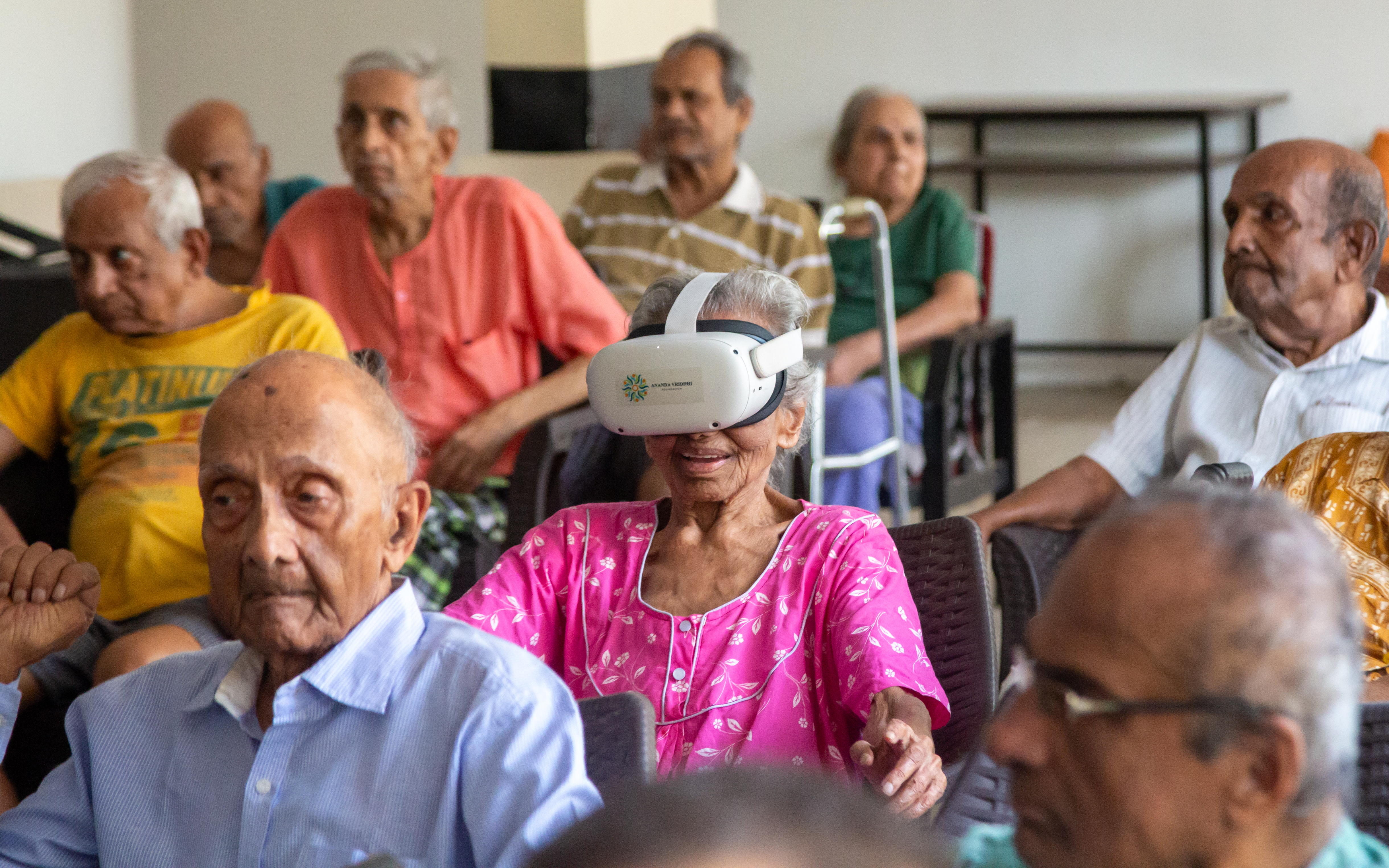 Senior citizens experiencing VR tours at an old age home